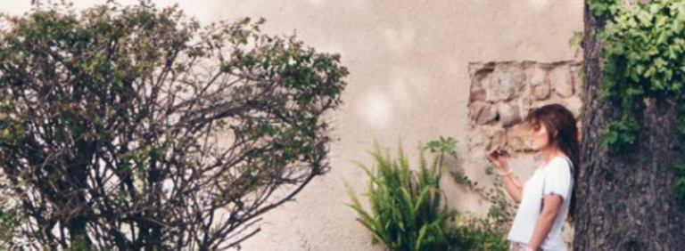 Gateways Growing Together image of woman leaning against tree